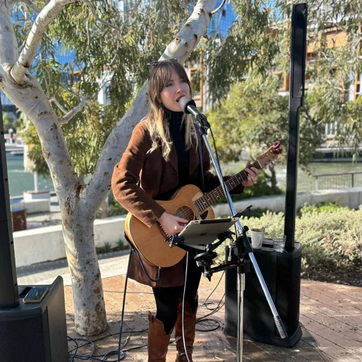 Live music Perth, musician performing an acoustic set outdoors, promoting events in Perth